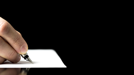 Male hand ready to write with a fountain pen